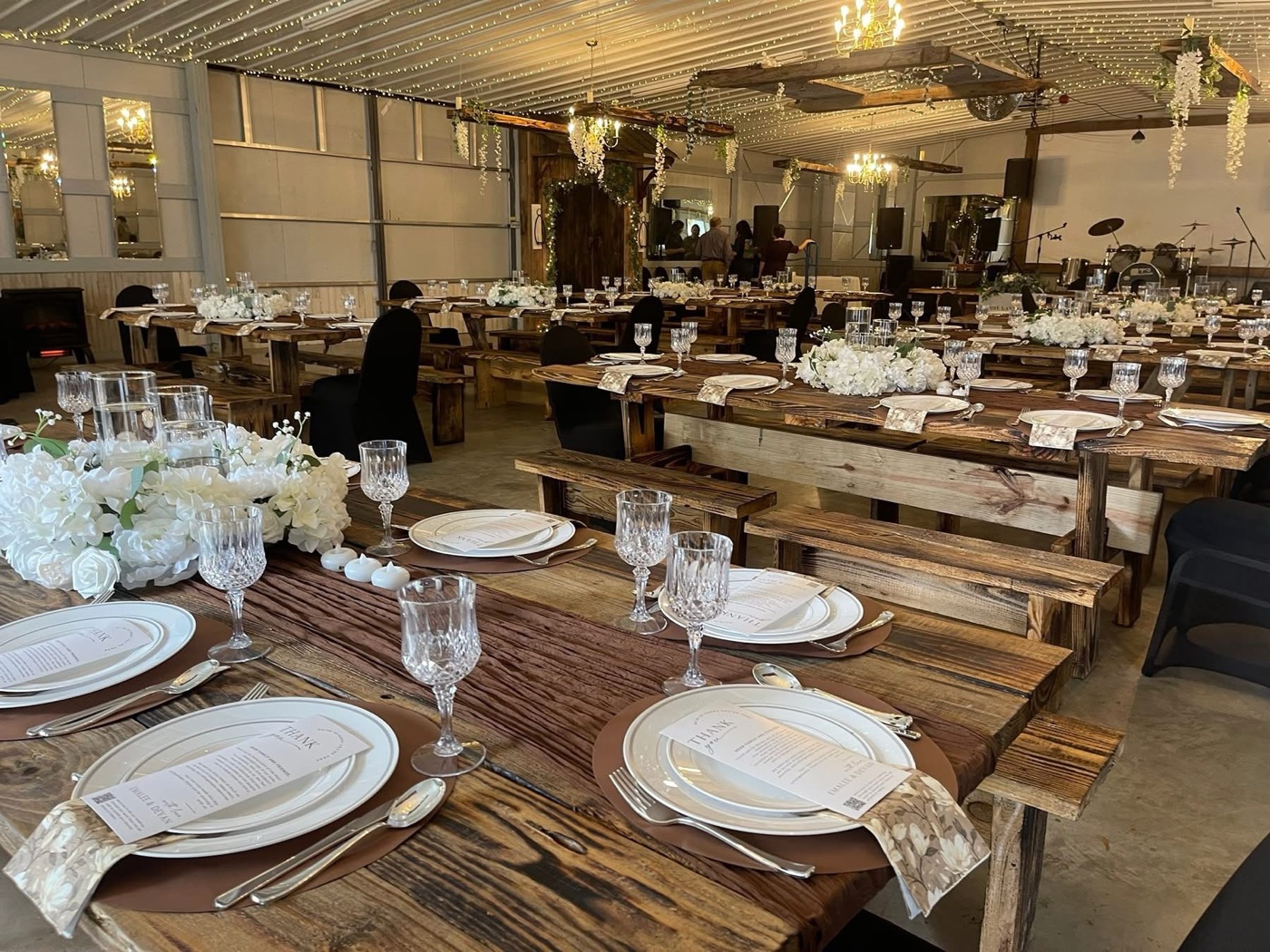 Handcrafted farm tables set for an outdoor reception