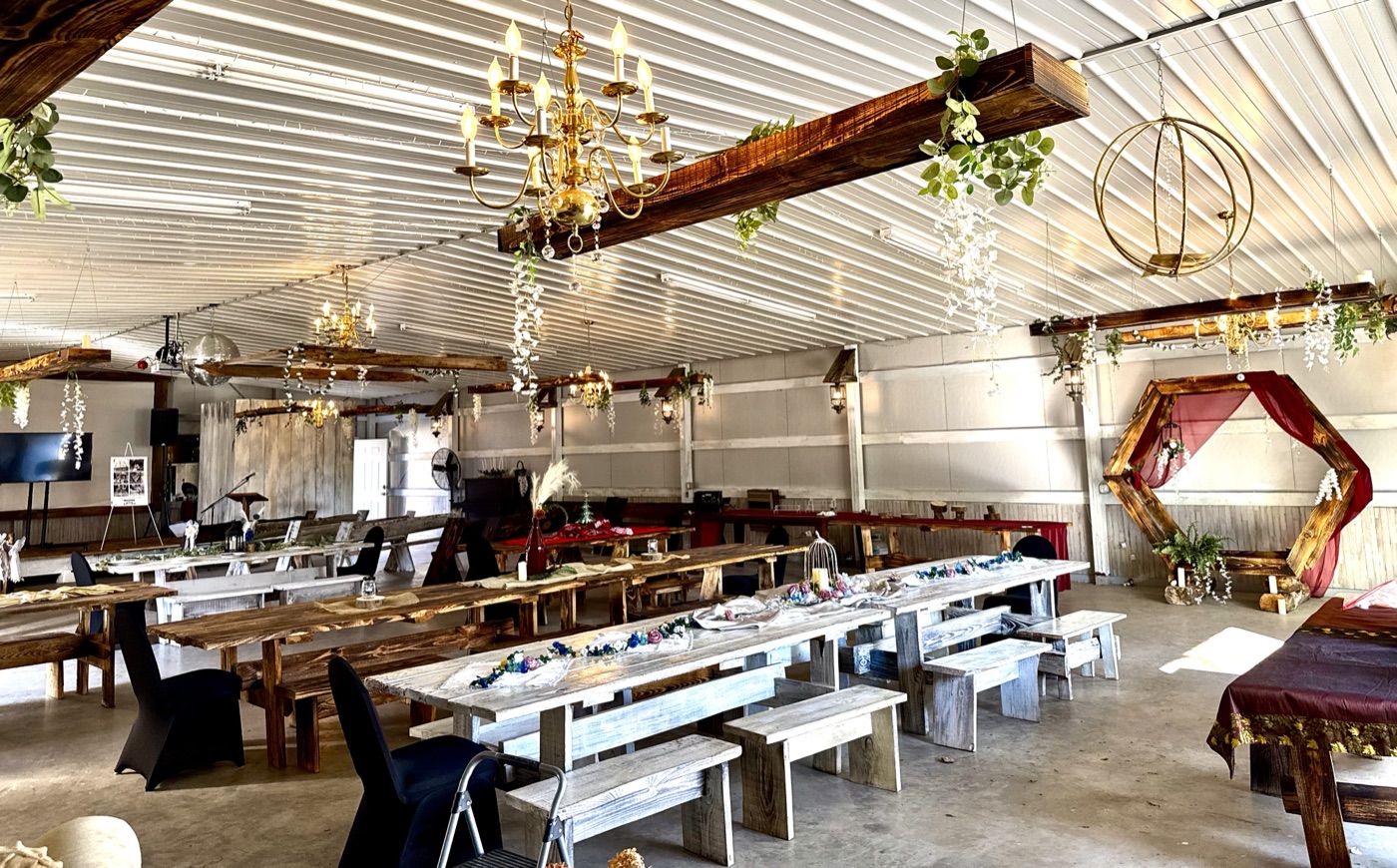 Reception Hall interior with farm tables, chandeliers, and hexagon arch